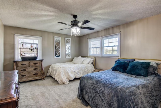 303 W Maple St, Thorp, WI 54771 - bedroom featuring carpet, a textured ceiling, and ceiling fan