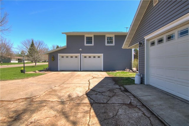 303 W Maple St, Thorp, WI 54771 - view of side of property with a garage