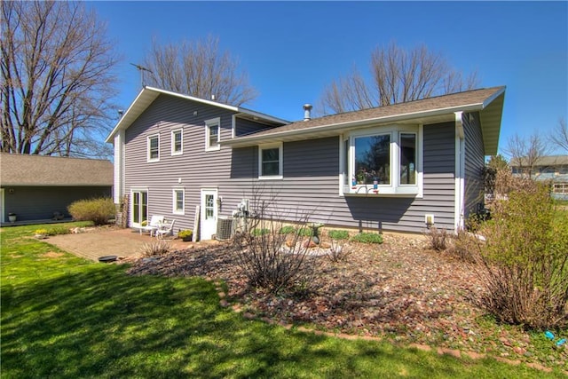 303 W Maple St, Thorp, WI 54771 - rear view of house with a yard, a patio area, and central AC unit