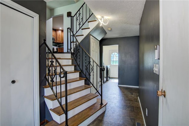 303 W Maple St, Thorp, WI 54771 - stairs featuring baseboards and a textured ceiling