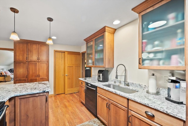 3271 Bay Hill Rd, Port Washington, WI 53074 - kitchen with black dishwasher, a sink, light wood-type flooring, light stone countertops, and pendant lighting