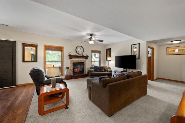 3271 Bay Hill Rd, Port Washington, WI 53074 - living area with a ceiling fan, a glass covered fireplace, and baseboards