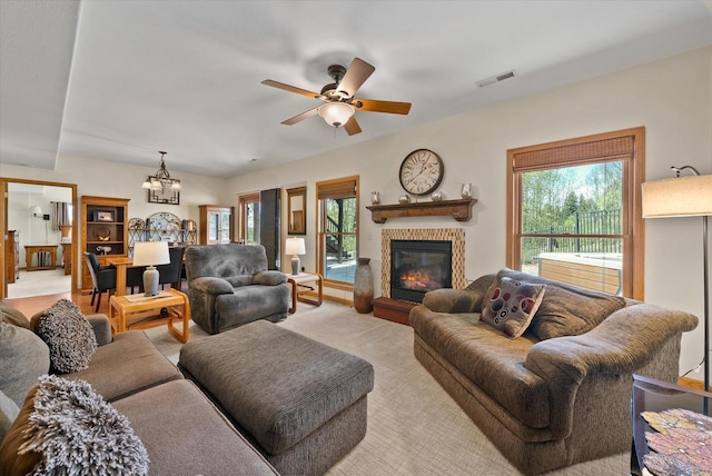 3271 Bay Hill Rd, Port Washington, WI 53074 - living area with a ceiling fan, a chandelier, a glass covered fireplace, and light carpet