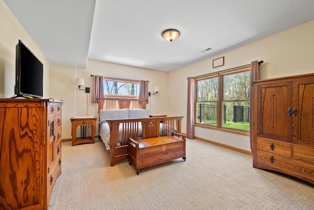 3271 Bay Hill Rd, Port Washington, WI 53074 - bedroom with multiple windows, light carpet, and baseboards