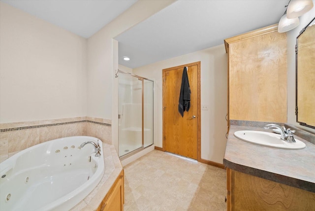 3271 Bay Hill Rd, Port Washington, WI 53074 - full bath featuring a stall shower, vanity, a tub with jets, and baseboards