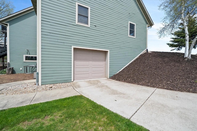3271 Bay Hill Rd, Port Washington, WI 53074 - view of side of home with an attached garage and concrete driveway
