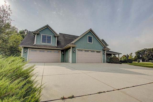 3271 Bay Hill Rd, Port Washington, WI 53074 - craftsman house featuring concrete driveway, roof with shingles, and a garage