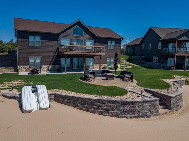 N8657 Lake Cabin Dr, New Lisbon, WI 53950 - back of house with an outdoor living space, a patio area, a lawn, and stone siding