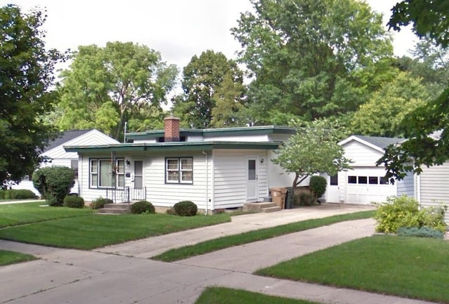49 Schenk St, Madison, WI 53714 - ranch-style house featuring a chimney, a garage, concrete driveway, and a front lawn