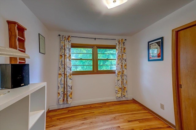 49 Schenk St, Madison, WI 53714 - unfurnished room featuring wood finished floors, baseboards, and a desk