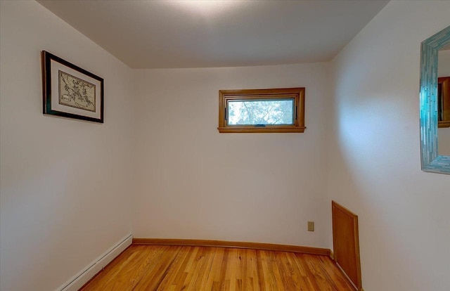49 Schenk St, Madison, WI 53714 - unfurnished room with baseboards, light wood-type flooring, and a baseboard radiator