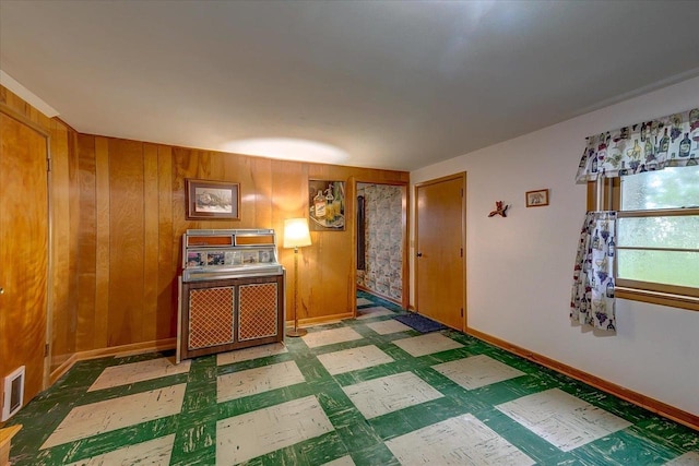 49 Schenk St, Madison, WI 53714 - spare room featuring tile patterned floors, wooden walls, and baseboards