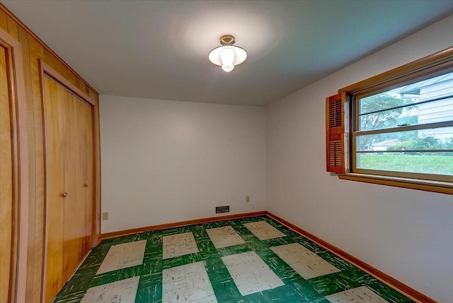 49 Schenk St, Madison, WI 53714 - unfurnished bedroom featuring baseboards, dark flooring, and a closet