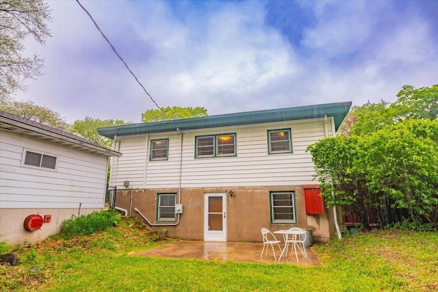 49 Schenk St, Madison, WI 53714 - back of house featuring a patio and a lawn