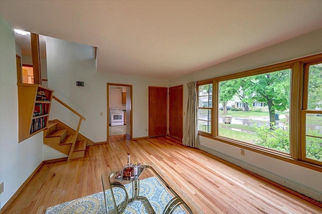 49 Schenk St, Madison, WI 53714 - unfurnished living room featuring light wood-type flooring, baseboards, and stairway