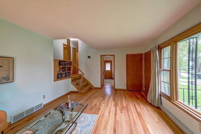 49 Schenk St, Madison, WI 53714 - unfurnished living room featuring plenty of natural light, light wood-style flooring, baseboards, and stairs