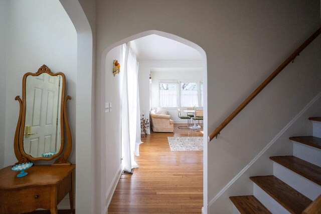 395 Lake St, Green Lake, WI 54941 - corridor featuring arched walkways, wood finished floors, and stairway