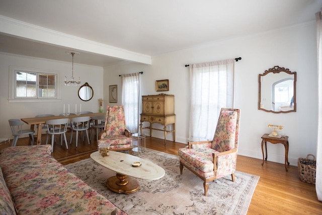 395 Lake St, Green Lake, WI 54941 - living area with healthy amount of natural light, light wood-style flooring, a chandelier, and crown molding