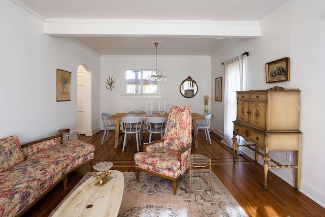 395 Lake St, Green Lake, WI 54941 - living area with wood finished floors, arched walkways, a chandelier, baseboards, and crown molding