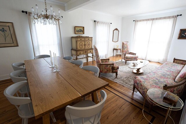 395 Lake St, Green Lake, WI 54941 - dining area with wood finished floors, ornamental molding, and a chandelier