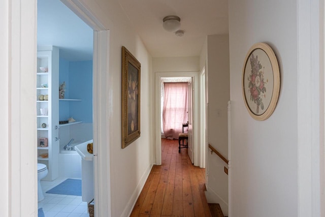 395 Lake St, Green Lake, WI 54941 - corridor with an upstairs landing, light wood-type flooring, and baseboards