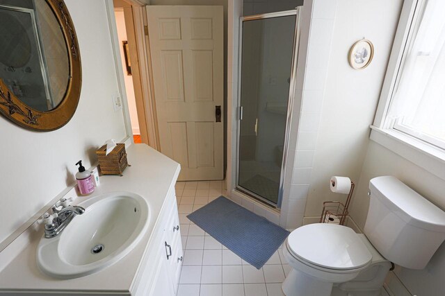395 Lake St, Green Lake, WI 54941 - bathroom featuring a shower stall, tile patterned floors, toilet, and vanity