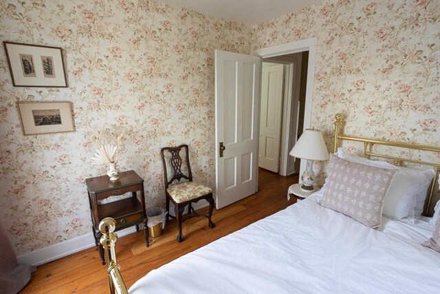 395 Lake St, Green Lake, WI 54941 - bedroom with wood finished floors and wallpapered walls