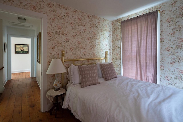 395 Lake St, Green Lake, WI 54941 - bedroom featuring wood-type flooring and wallpapered walls