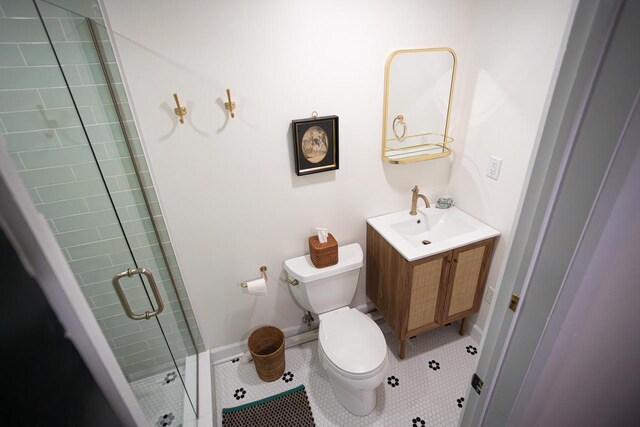 395 Lake St, Green Lake, WI 54941 - full bathroom featuring a stall shower, tile patterned floors, toilet, vanity, and baseboards