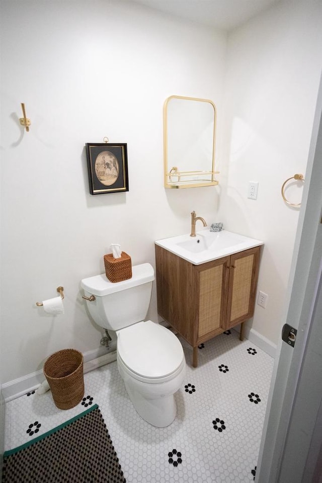 395 Lake St, Green Lake, WI 54941 - bathroom with toilet, vanity, tile patterned floors, and baseboards