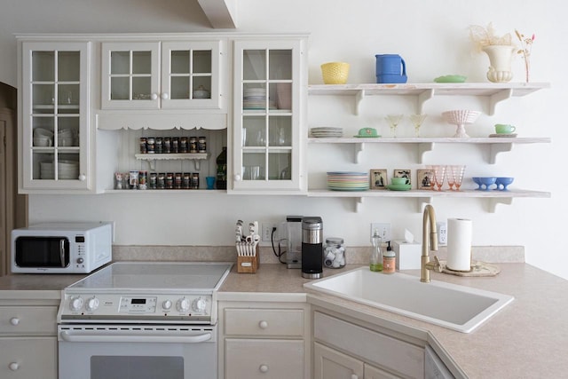395 Lake St, Green Lake, WI 54941 - kitchen featuring white appliances, a sink, open shelves, and glass insert cabinets