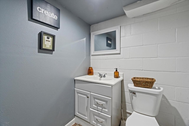 half bathroom with vanity and toilet