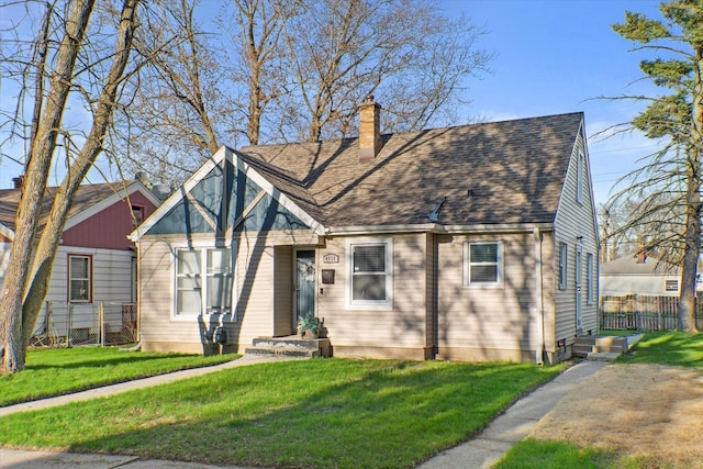 view of front facade with a chimney and a shingled roof