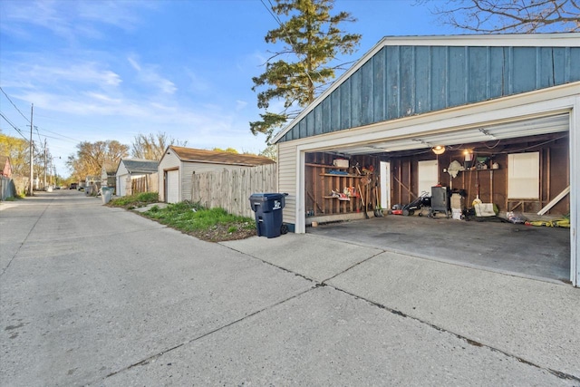 detached garage featuring fence