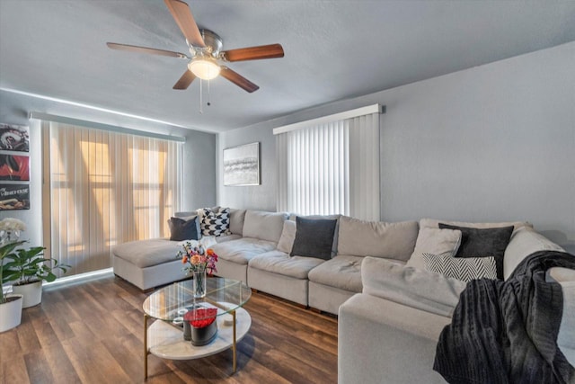 living area with a ceiling fan and wood finished floors