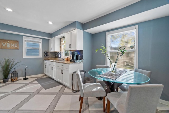 dining area featuring baseboards and recessed lighting