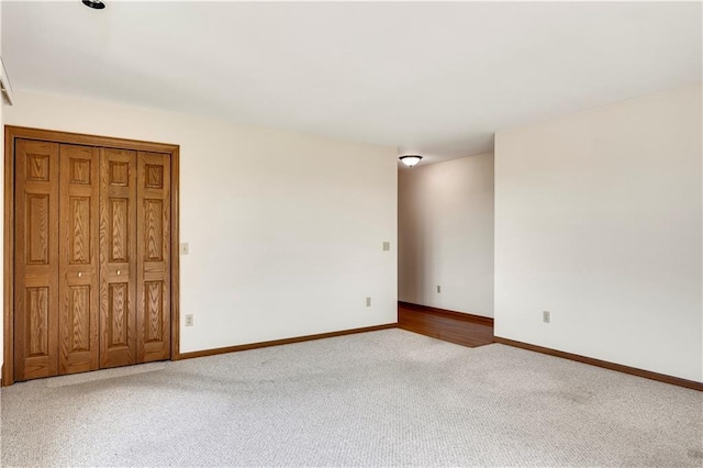 carpeted spare room with baseboards