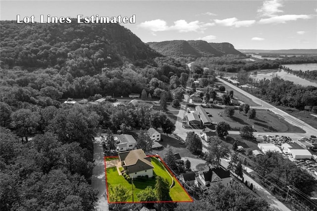 view of property location featuring property boundaries highlighted, a heavily wooded area, and mountains
