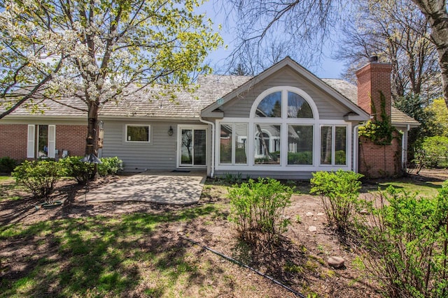 2415 Walnut Grove Ct Unit B, Brookfield, WI 53005 - back of property with a patio, a chimney, and brick siding