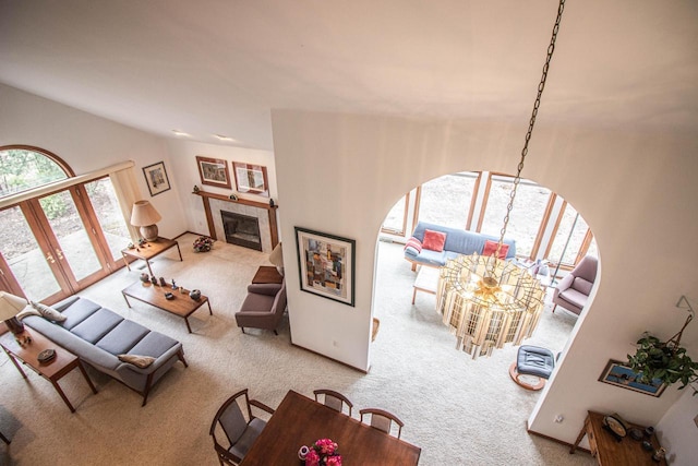 2415 Walnut Grove Ct Unit B, Brookfield, WI 53005 - living area featuring carpet flooring, arched walkways, a fireplace, and vaulted ceiling