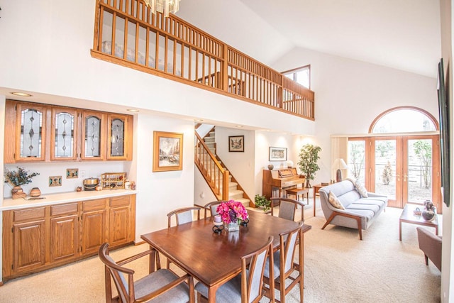 2415 Walnut Grove Ct Unit B, Brookfield, WI 53005 - dining space with high vaulted ceiling, light colored carpet, stairway, and french doors