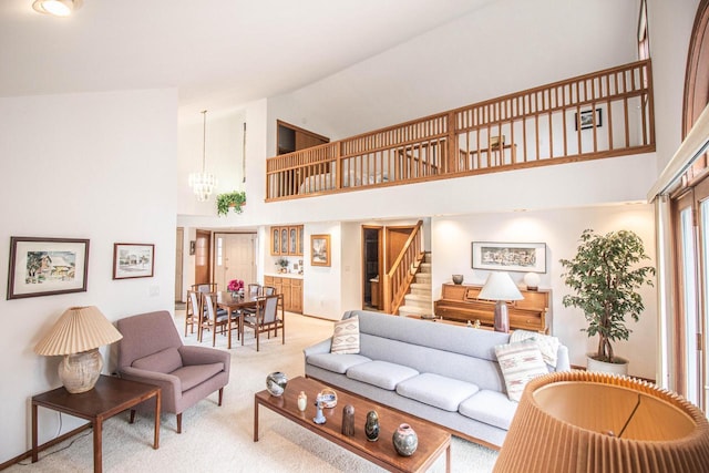 2415 Walnut Grove Ct Unit B, Brookfield, WI 53005 - living room with high vaulted ceiling, light colored carpet, a chandelier, and stairs