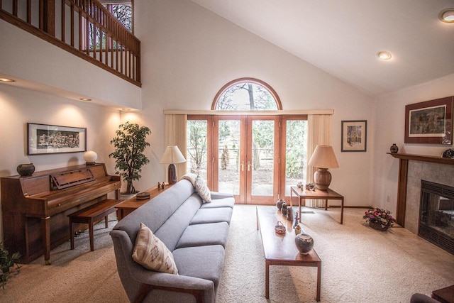 2415 Walnut Grove Ct Unit B, Brookfield, WI 53005 - carpeted living room with high vaulted ceiling, french doors, a tile fireplace, recessed lighting, and baseboards
