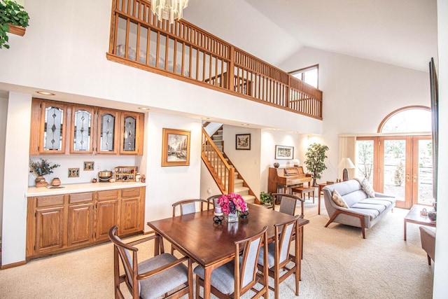 2415 Walnut Grove Ct Unit B, Brookfield, WI 53005 - dining area with high vaulted ceiling, light colored carpet, stairway, and plenty of natural light
