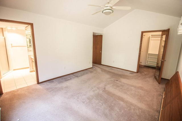 2415 Walnut Grove Ct Unit B, Brookfield, WI 53005 - unfurnished bedroom featuring carpet, lofted ceiling, a walk in closet, ensuite bathroom, and a closet