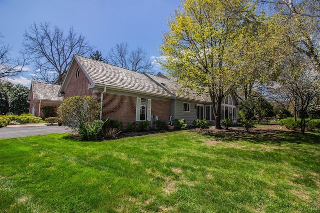 2415 Walnut Grove Ct Unit B, Brookfield, WI 53005 - view of front facade with brick siding, asphalt driveway, and a front yard