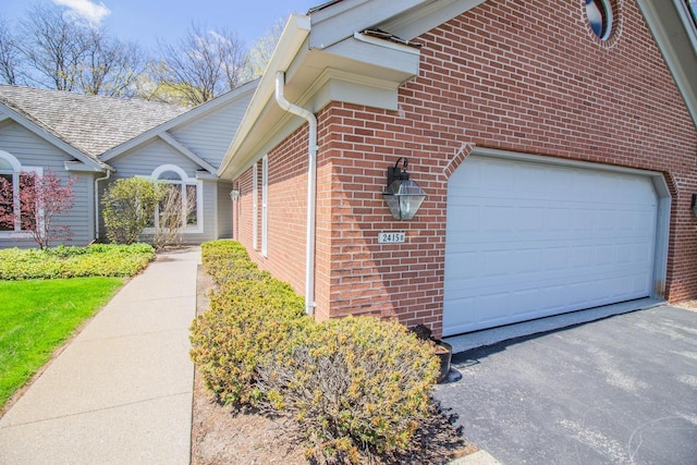 2415 Walnut Grove Ct Unit B, Brookfield, WI 53005 - view of property exterior with brick siding, a garage, and asphalt driveway