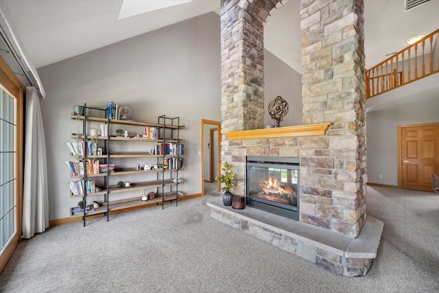 135 Emerald Dr, Mount Pleasant, WI 53406 - carpeted living room featuring high vaulted ceiling, a stone fireplace, baseboards, and ornate columns