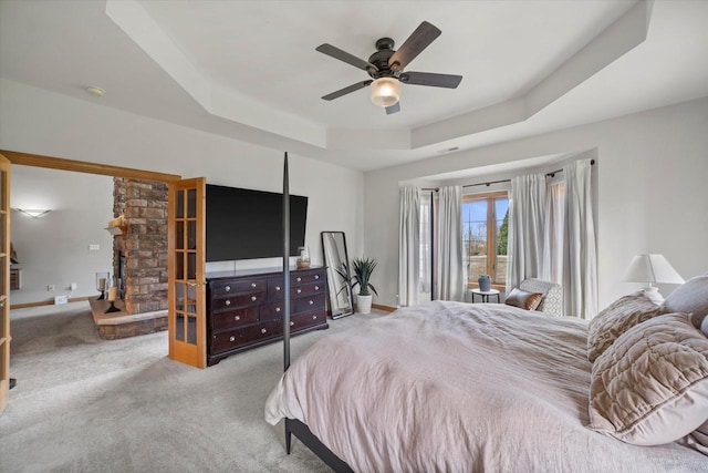 135 Emerald Dr, Mount Pleasant, WI 53406 - bedroom featuring a tray ceiling, carpet floors, baseboards, and a ceiling fan