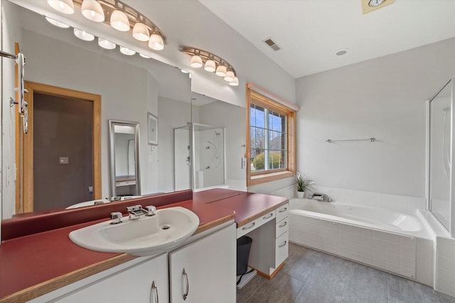 135 Emerald Dr, Mount Pleasant, WI 53406 - bathroom featuring a stall shower, a garden tub, and vanity